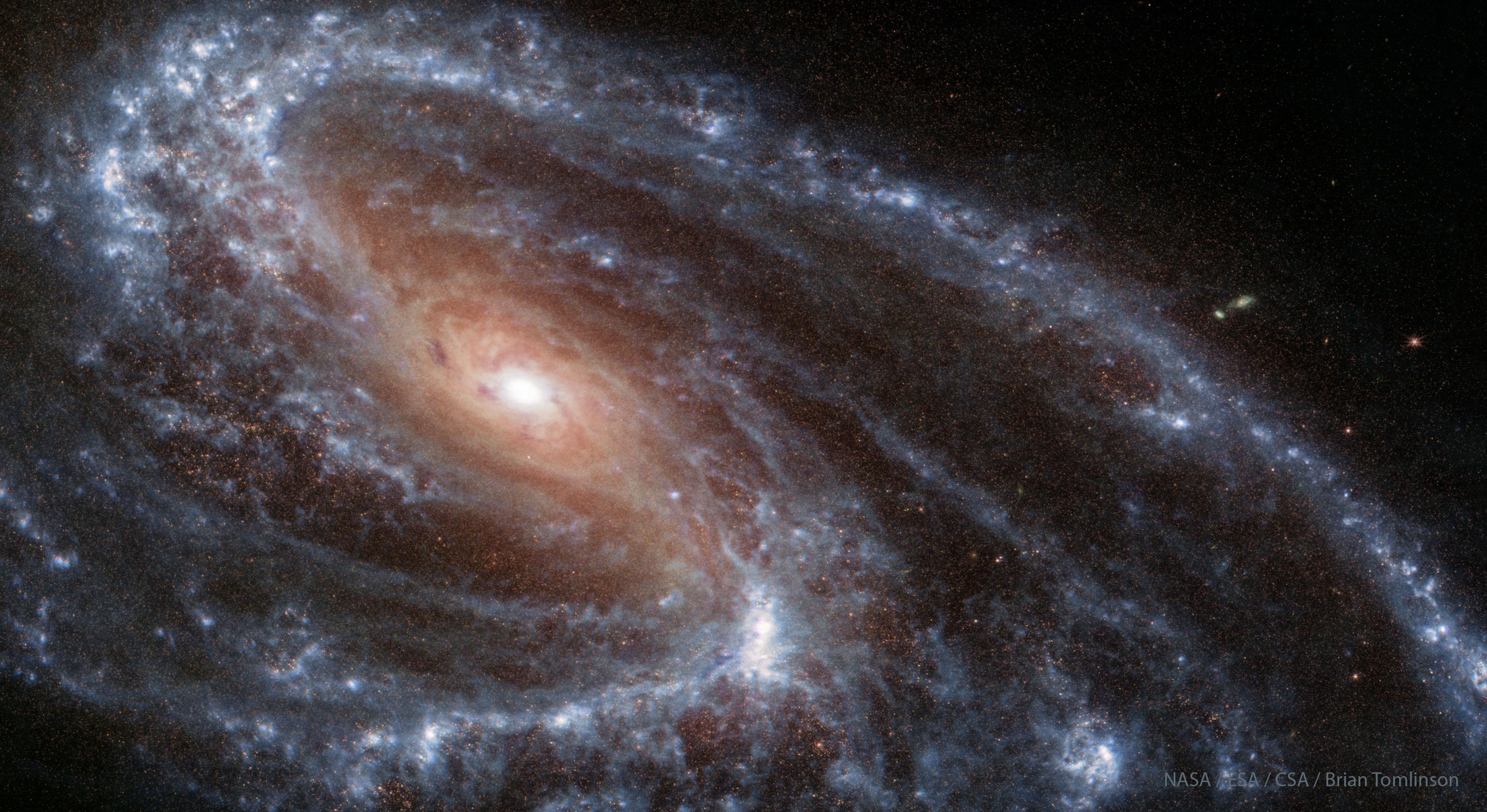 تظهر المجرّة الحلزونيّة م66 في الضوء تحت الأحمر كما تُرى بواسطة تلسكوب جيمس وِبّ الفضائي المداري. يُرى في المجرّة مركزٌ بنيٌّ مُحمرّ مع أذرعٍ حلزونيّة زرقاء اللون تحيط به. ستكشف نظرةٌ عن كثب أنّ هذه الأذرع الحلزونيّة ليست متناظرة.